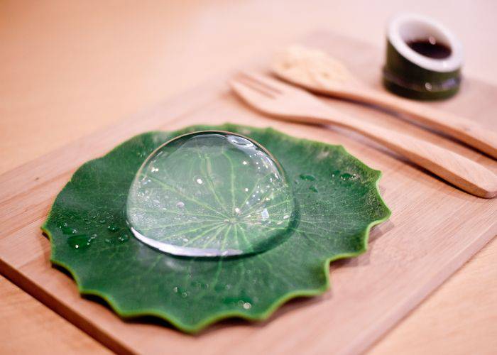 A serving of Mizu Shingen Mochi, served on a leaf and looking like a large raindrop.